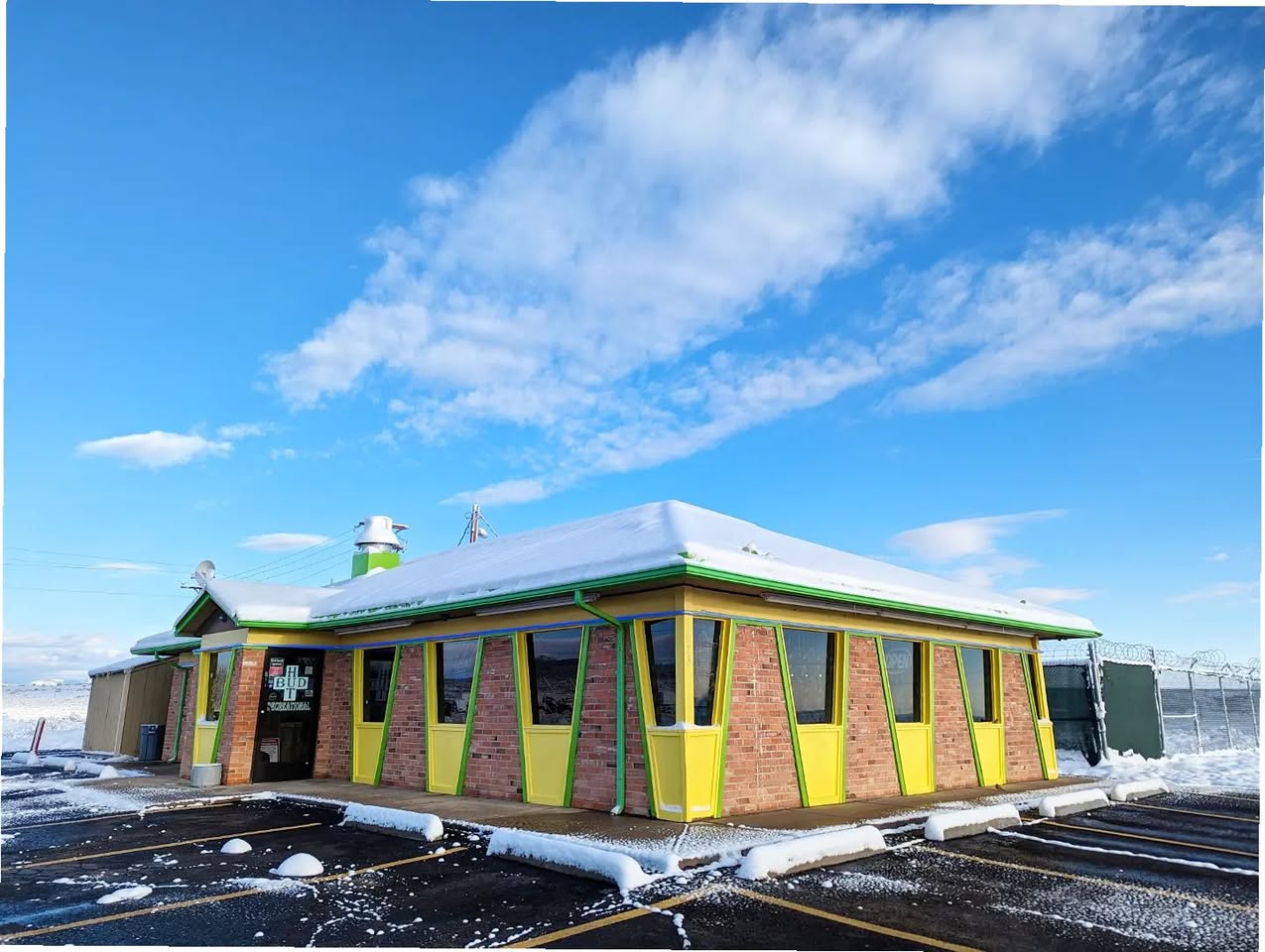 The Bud Hut, a cannabis dispensary in a converted former Pizza Hut building in rural Colorado, with the unmistakable hut-shaped roofline still intact