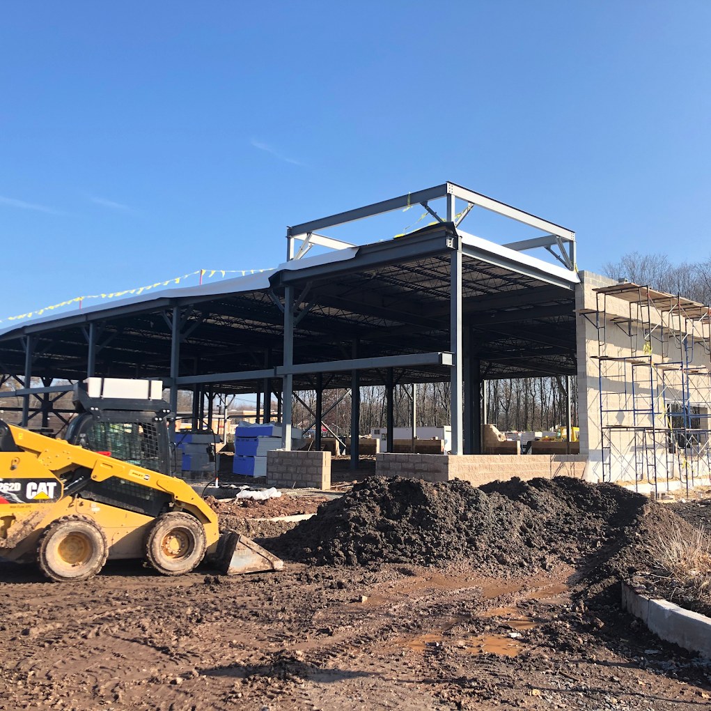 Riya Commons under construction — structural steel frame being erected on the Route 27 site